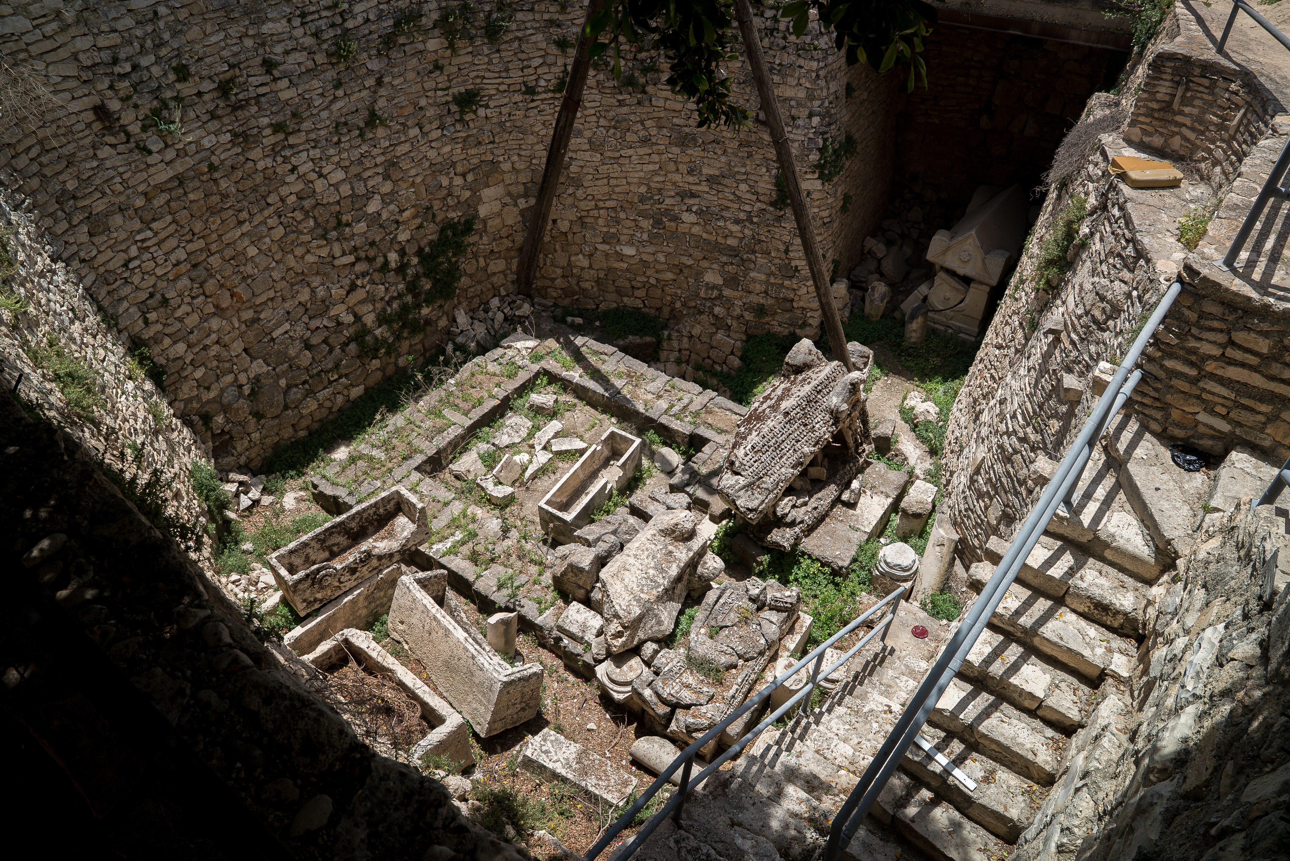 A close up of Roman ruins in the grass of an archaeological site in Sebastia.