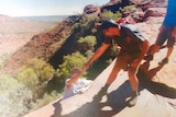 A tour guide poses with a tourist in Kings Canyon