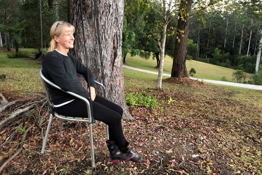 Sandy Brennan sitting in a tree swing.
