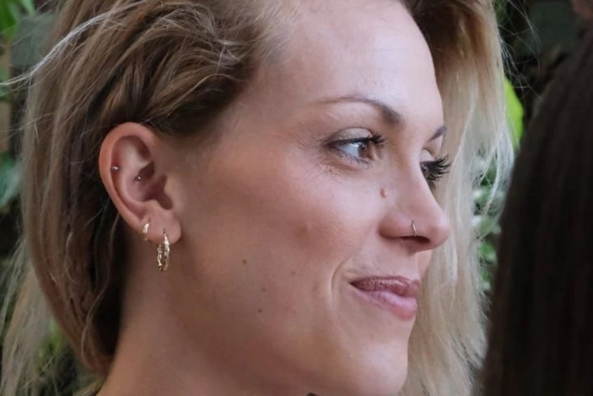 A supplied photo of a blonde woman smiling and looking off-camera.