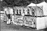 A line of tent boxers stand outside Harry Paulsen's Touring Stadium in this black and white photo from 1946.
