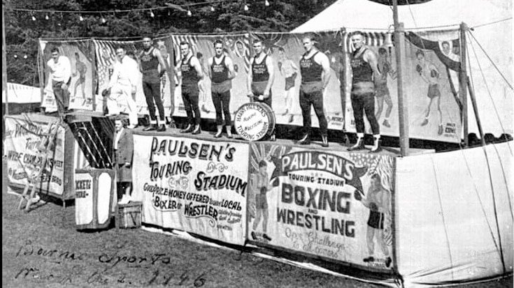 A line of tent boxers stand outside Harry Paulsen's Touring Stadium in this black and white photo from 1946.