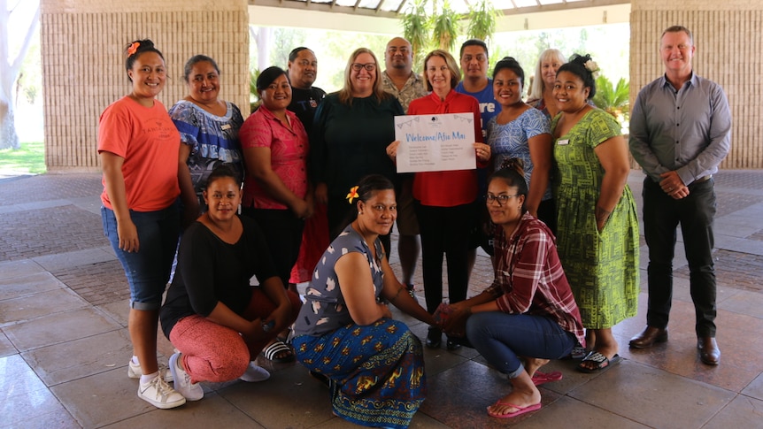 group of samoan workers smiling with hotel staff and Minister Paul Kirby