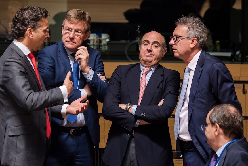 Four ministers: Jeroen Dijsselbloem, Johan Van Overtveldt, Luis de Guindos, and Pierre Gramegna speak in a meeting in Luxembourg