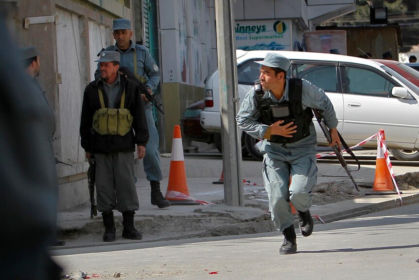 Afghan police take their positions as Kabul comes under fire.