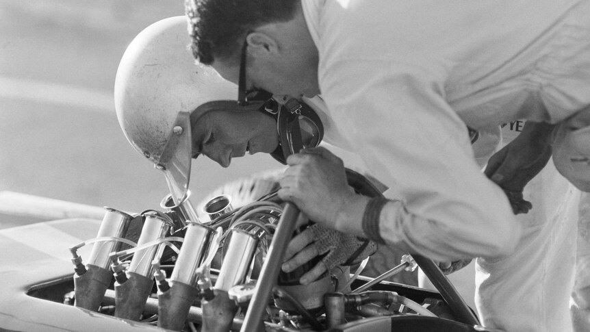 Jack Brabham checks his Repco Brabham engine before the start of an event at Surfers Paradise.