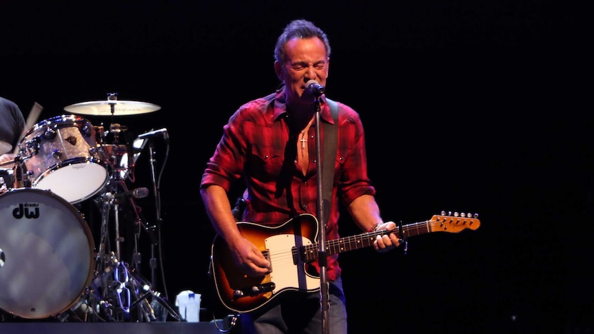 Bruce Springsteen plays guitar and sings during a performance with the E-Street band in Perth.