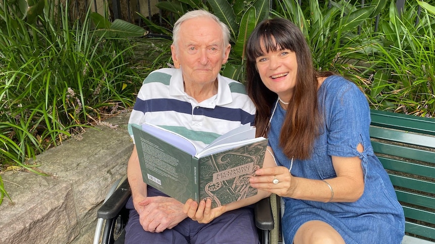 T. Carrick Chambers sitting with his daughter Claudia, who is holding her book Becoming a Botanist. 