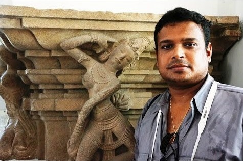 Indian antiquities sleuth Vijay Kumar in front of an antique