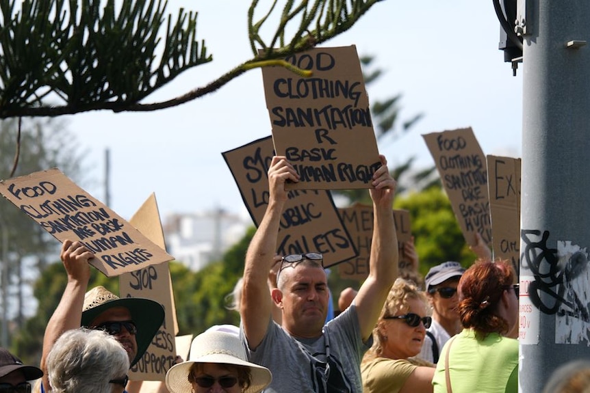 people with placards and signs protesting