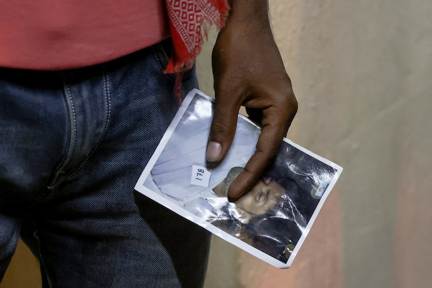 A hand holding a photo. 