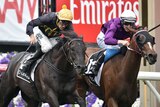 Dwayne Dunn (L) rides Excess Knowledge to beat Zanteca in the Lexus on Derby Day at Flemington.