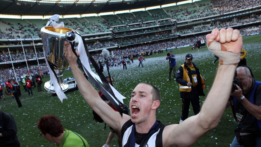 Nick Maxwell holds up the trophy after winning the 2010 AFL grand final replay against St Kilda.