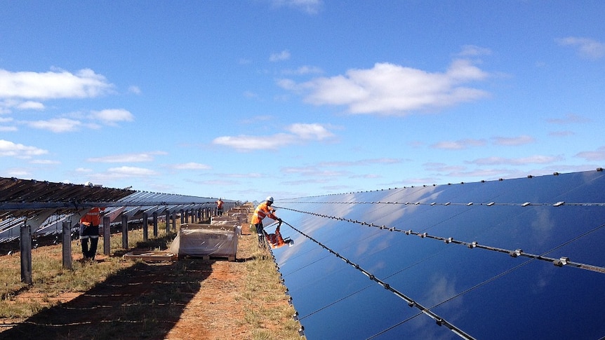 A man installs a solar farm