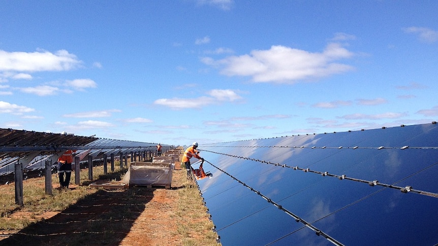 A man works on solar panels