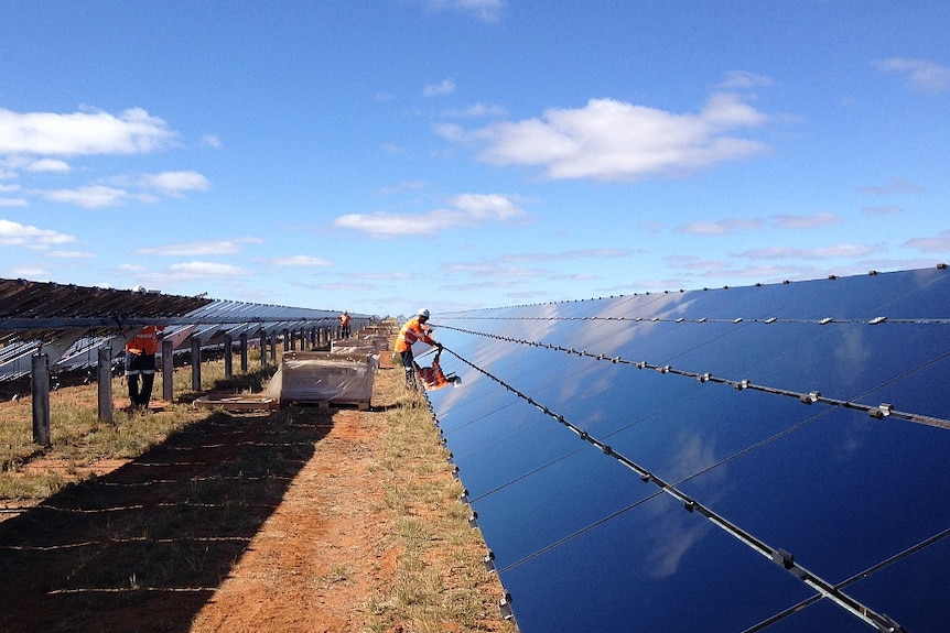 A man works on solar panels