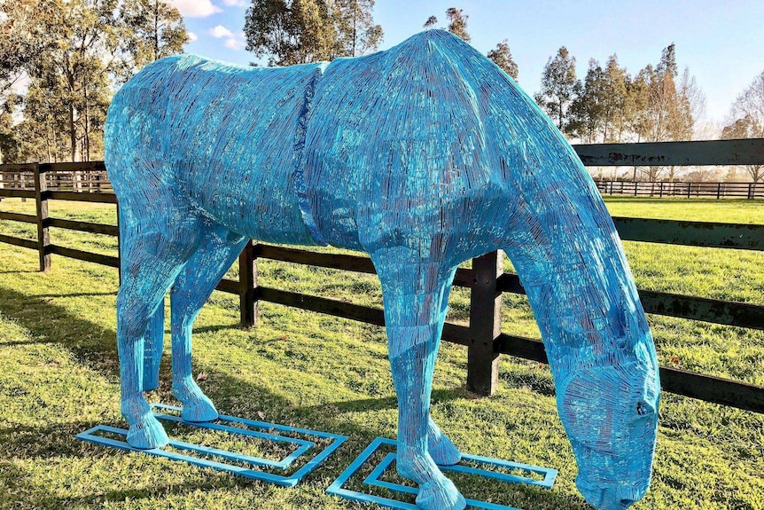 A 2.2 m high wire sculpture of a horse, painted blue.