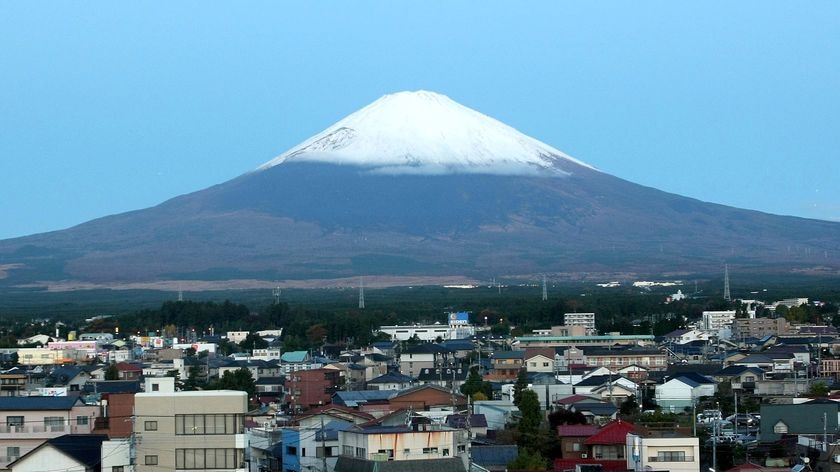 Snow covers the peak of Japan's Mount Fuji, with the city of Gotenba below
