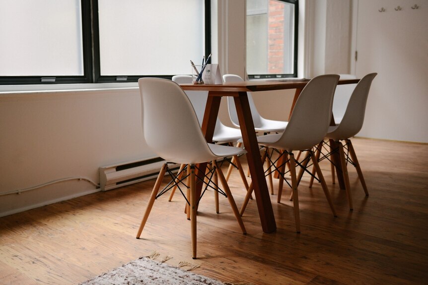 A dining table and Eames designer chairs.