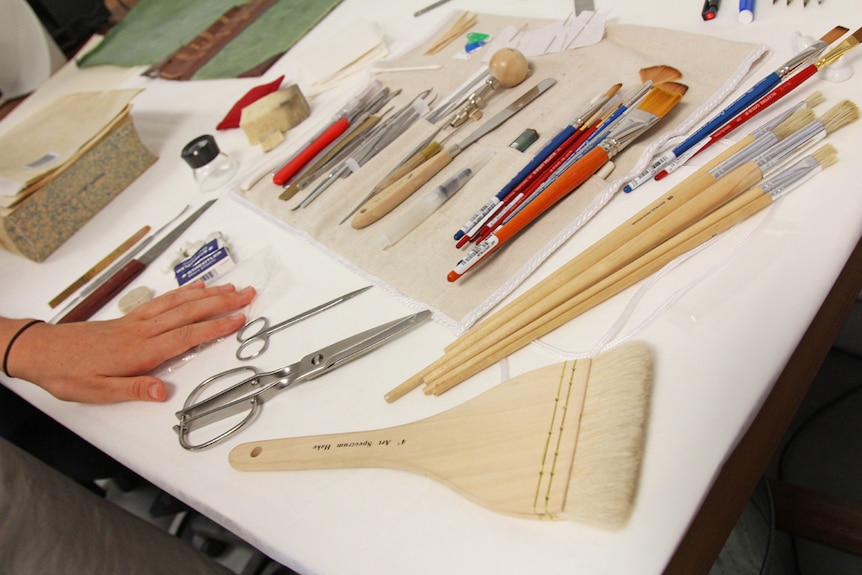 Tools and brushes laid out neatly on a table.