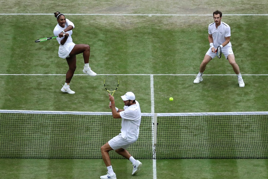 Serena Williams belts the ball at Fabrice Martin with Andy Murray alongside.
