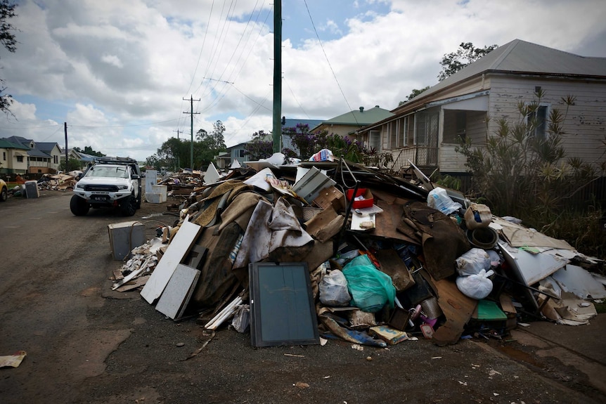Piles of debris and waste in a Lismore street.