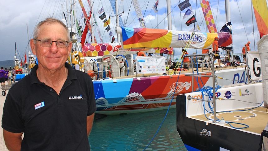 Ross Ham pictured in front of sailing yachts in Airlie Beach