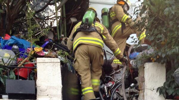 Crews access house of hoarded rubbish