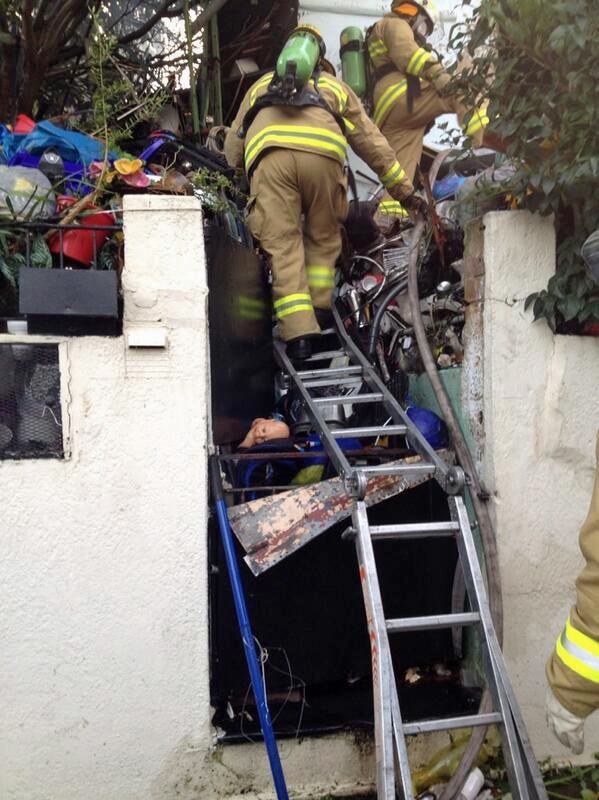 Crews access house of hoarded rubbish