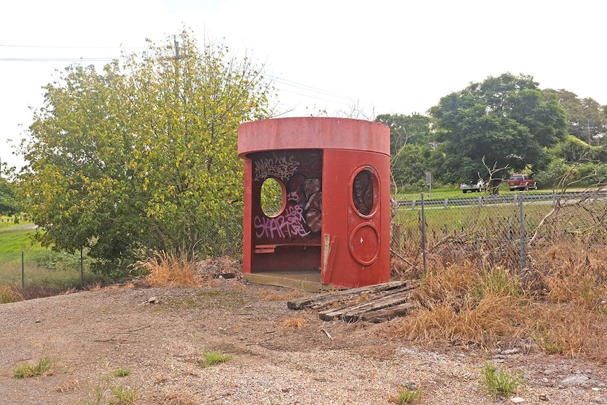 A red Canberra bus shelter in Maitland, NSW.