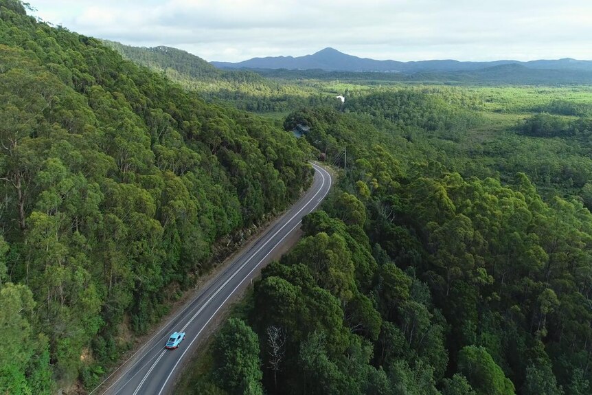 Aerial image of car on roadway during Targa Tasmania event.