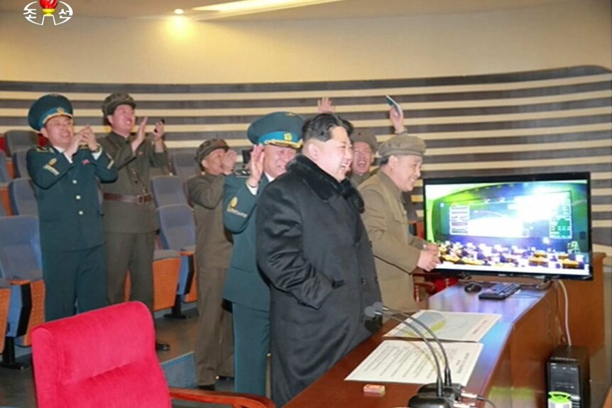North Korean leader Kim Jong-Un (3rd R) attending the rocket launch of earth observation satellite Kwangmyong 4
