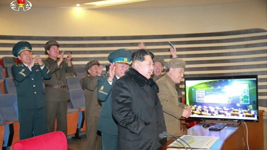 North Korean leader Kim Jong-Un (3rd R) attending the rocket launch of earth observation satellite Kwangmyong 4