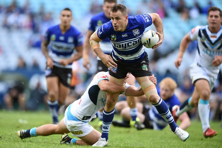 Josh Reynolds is tackled against Titans