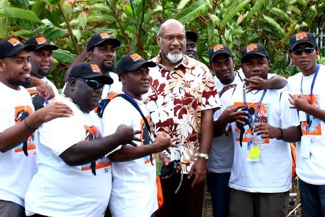A group of men in Pacific Break t-shirts with the then-PM of Vanuatu.