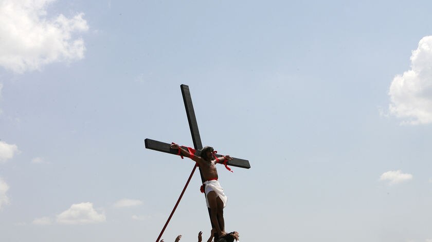 A man is nailed to a cross during a re-enactment of the crucifixion of Jesus Christ