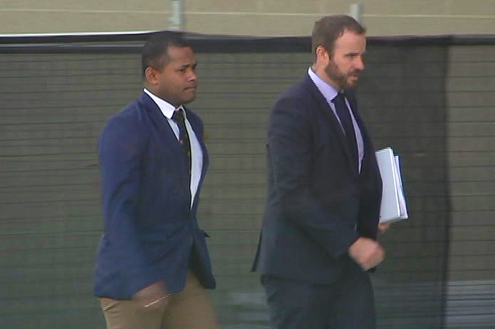 Samisoni Loloma Baikeitoga walks outside the court building in Canberra with his lawyer.