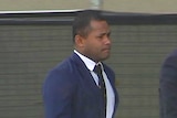 Samisoni Loloma Baikeitoga walks outside the court building in Canberra with his lawyer.