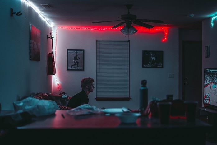teenager sits in his bedroom and stares straight ahead.