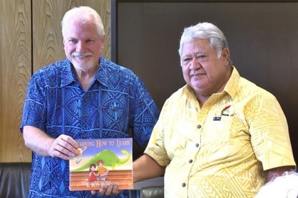 Samoa's Prime Minister Tuilaepa Sailele receives textbook from Applied Scholastics Ambassador Warren Meyer in 2018.