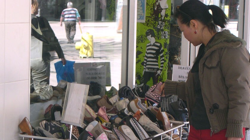 Woman buying shoes in Civic.