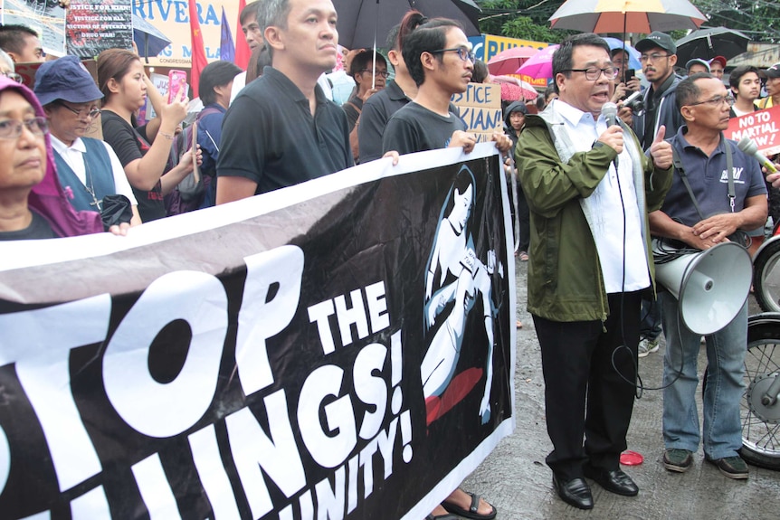 A community protest in Manila over the death of Kian delos Santos, with people holding signs.