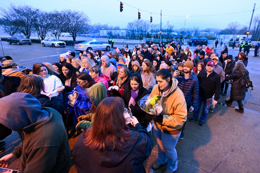 People line up to enter Graceland for Lisa Marie Presley's memorial service.