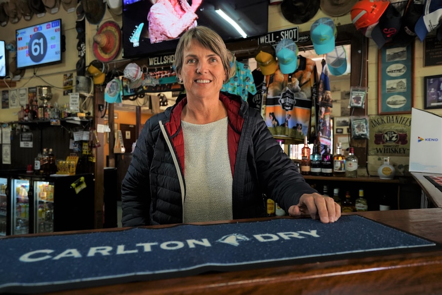 Woman standing behind bar