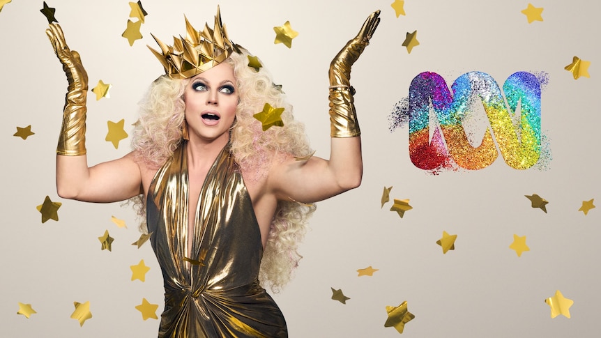 Drag queen Courtney Act surrounded by gold stars