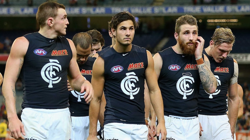Dejected Carlton players leave the field after an 81-point MCG loss to Essendon.