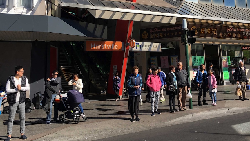 Hurstville train station with Chinese Australians clustered at the lights outside