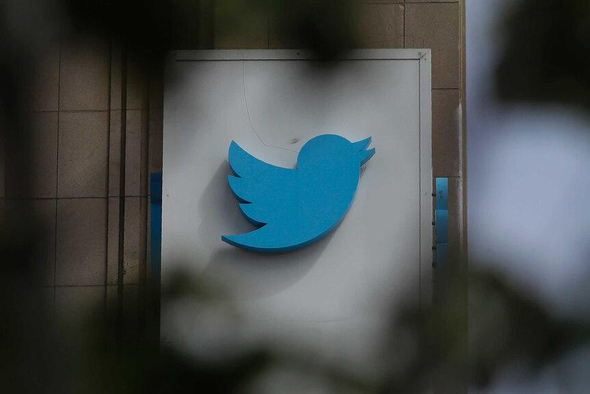 A Twitter logo on the side of a building showing its blue bird