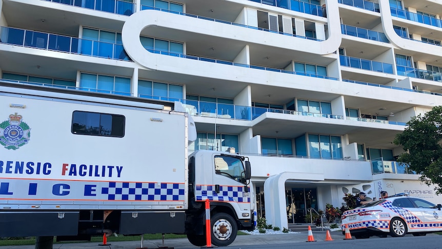 Police cars outside apartments.