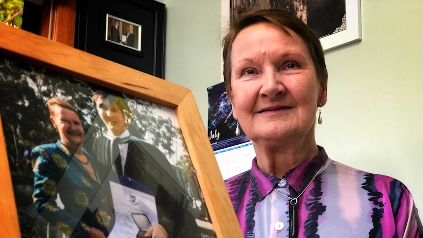 Tasmanian Association for the Gifted president Lynne Maher holding a photo of her son.